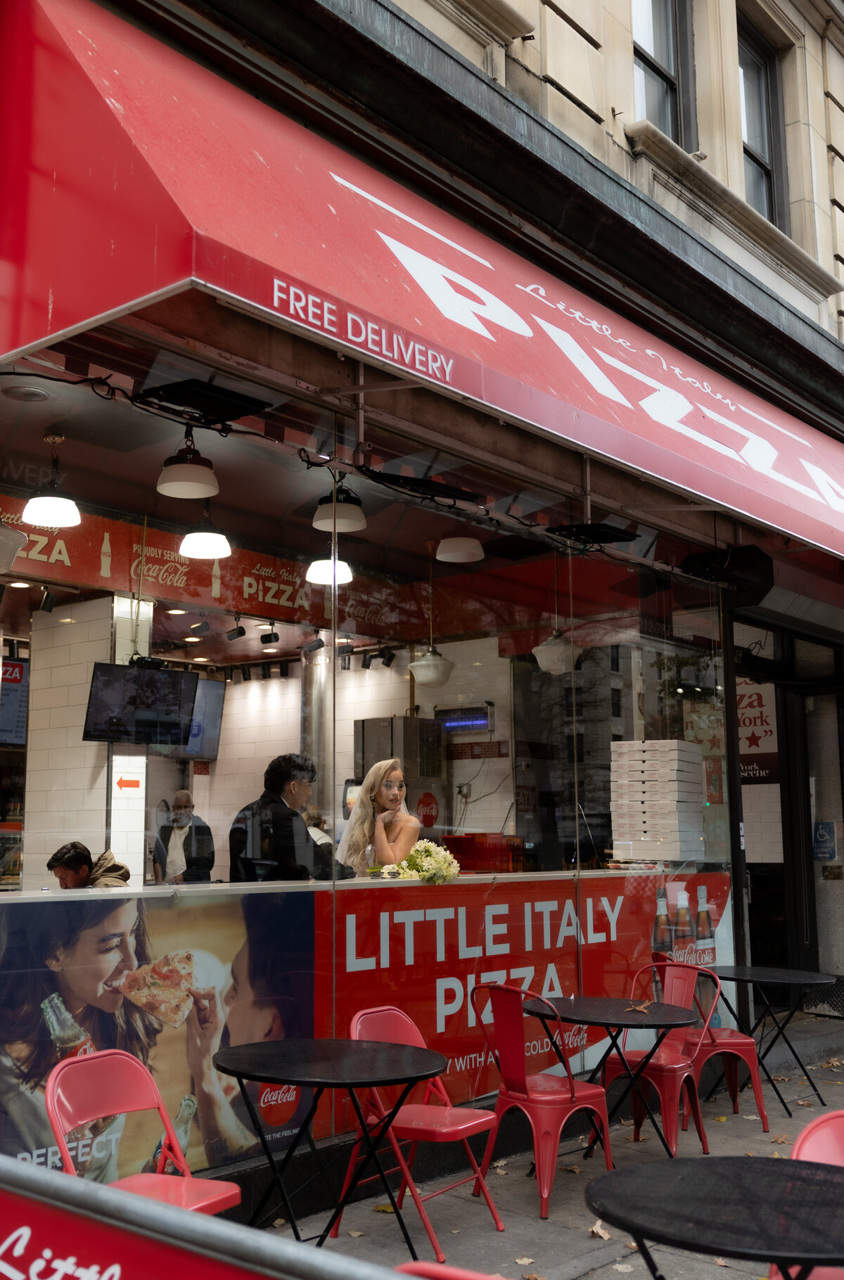 Neon sign glowing in an NYC pizza shop, captured during the couple’s urban elopement session.