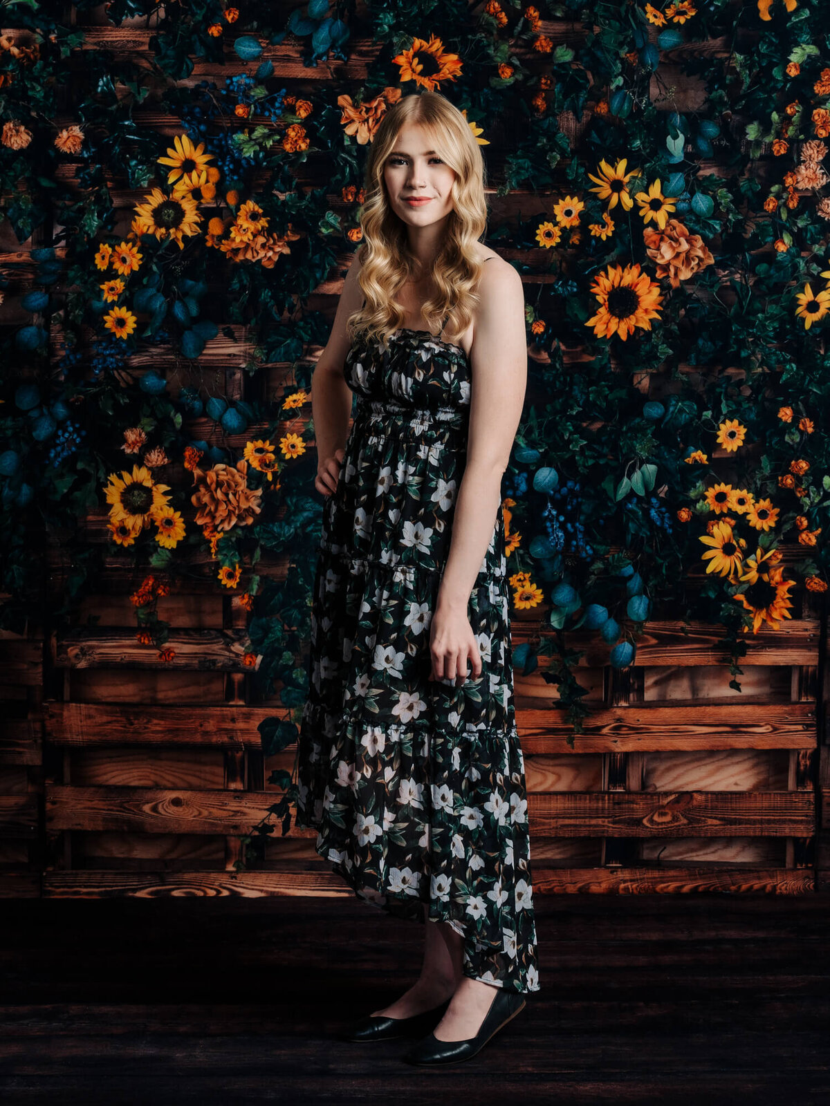 Girl poses in front of sunflowers in Prescott senior photography session