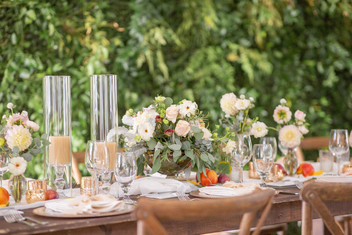 Head table at a wedding reception with flowers and candles