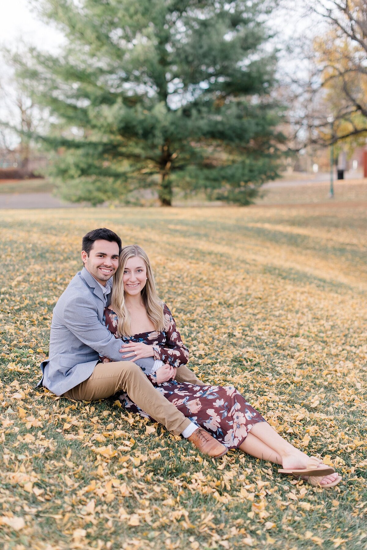 Couple sits in leaves at Franklin Park taken by the Best Ohio Wedding Photographer