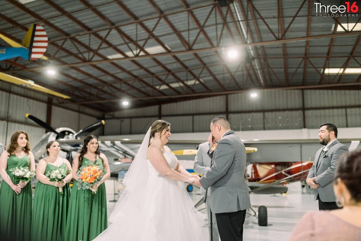 Bride listens as the Groom repeats his vows