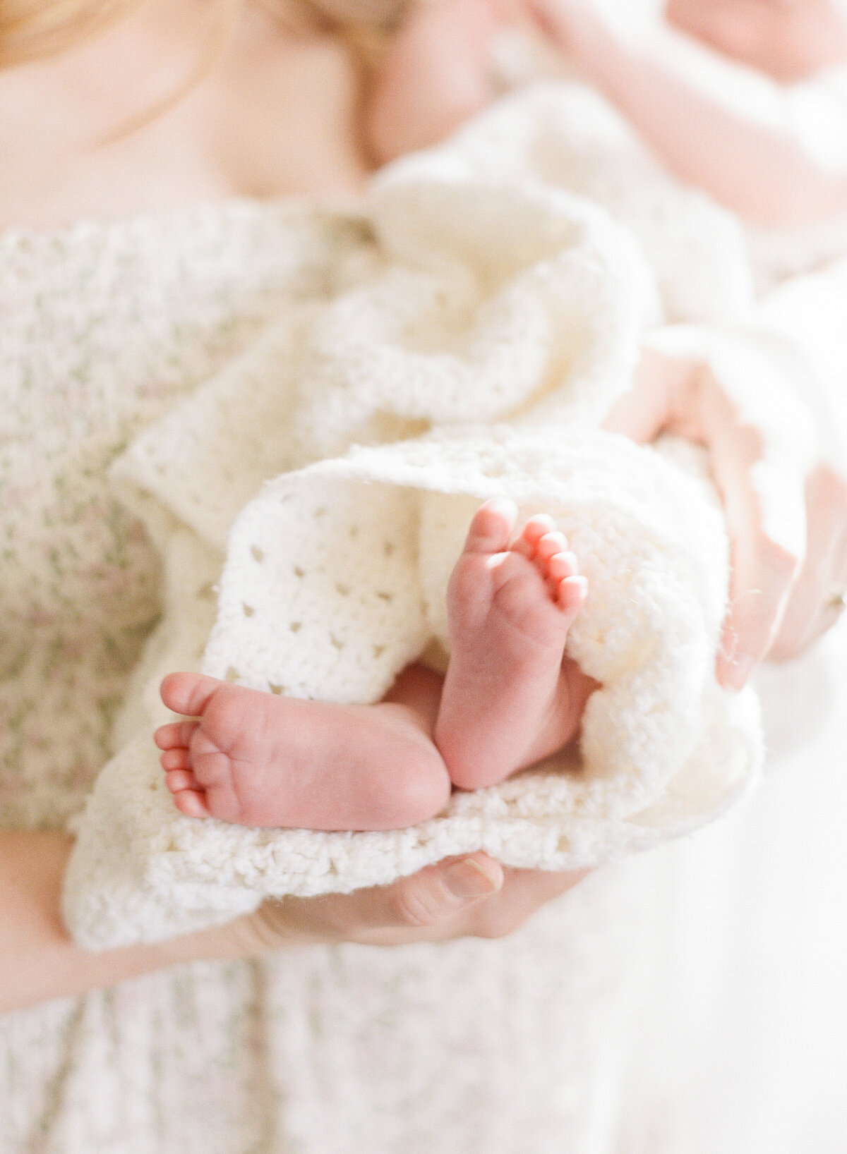 Close up of baby toes wrapped in a blanket. Image by Raleigh newborn photographer A.J. Dunlap Photography.