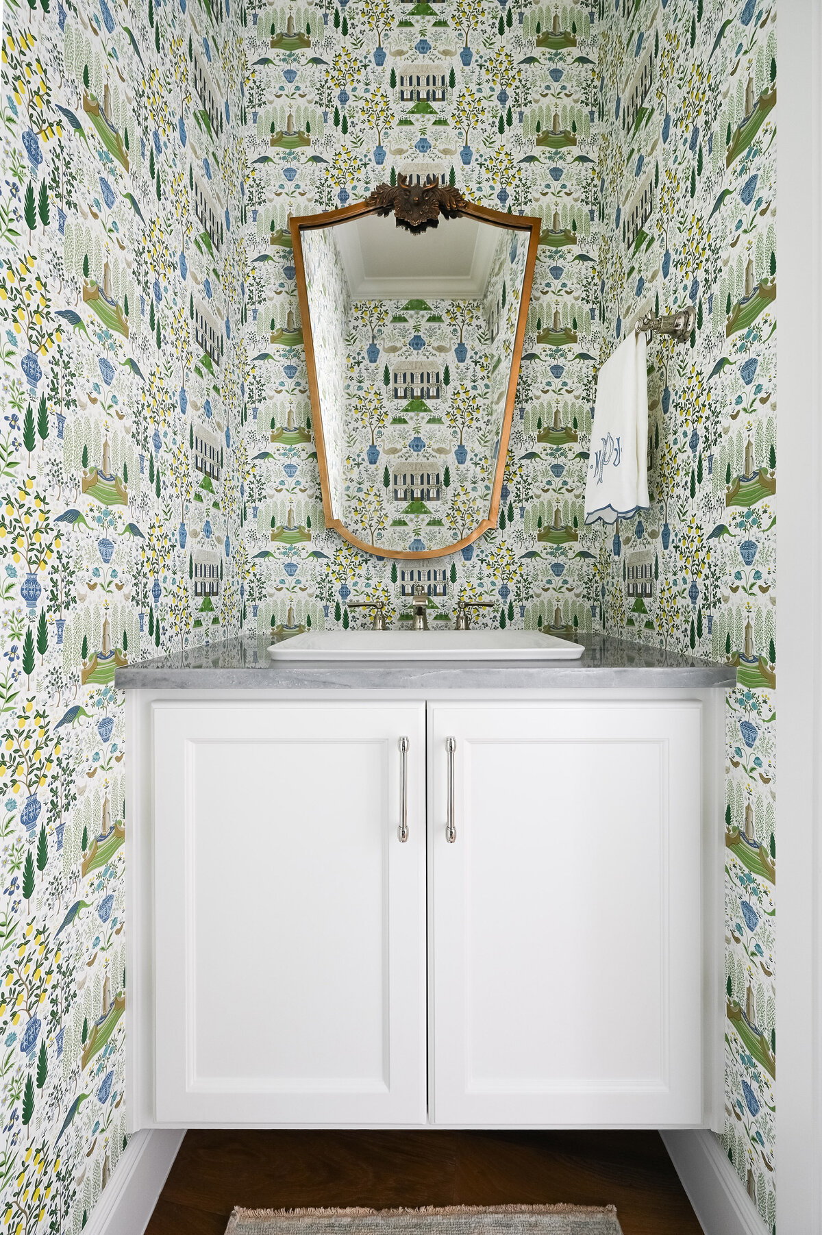 wallpapered bathroom over sink