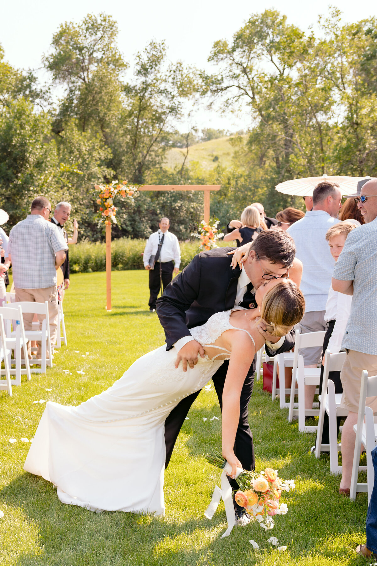 Bride and groom share a kiss after getting married at The Barn at 52 Pines in Burlington, North Dakota.
