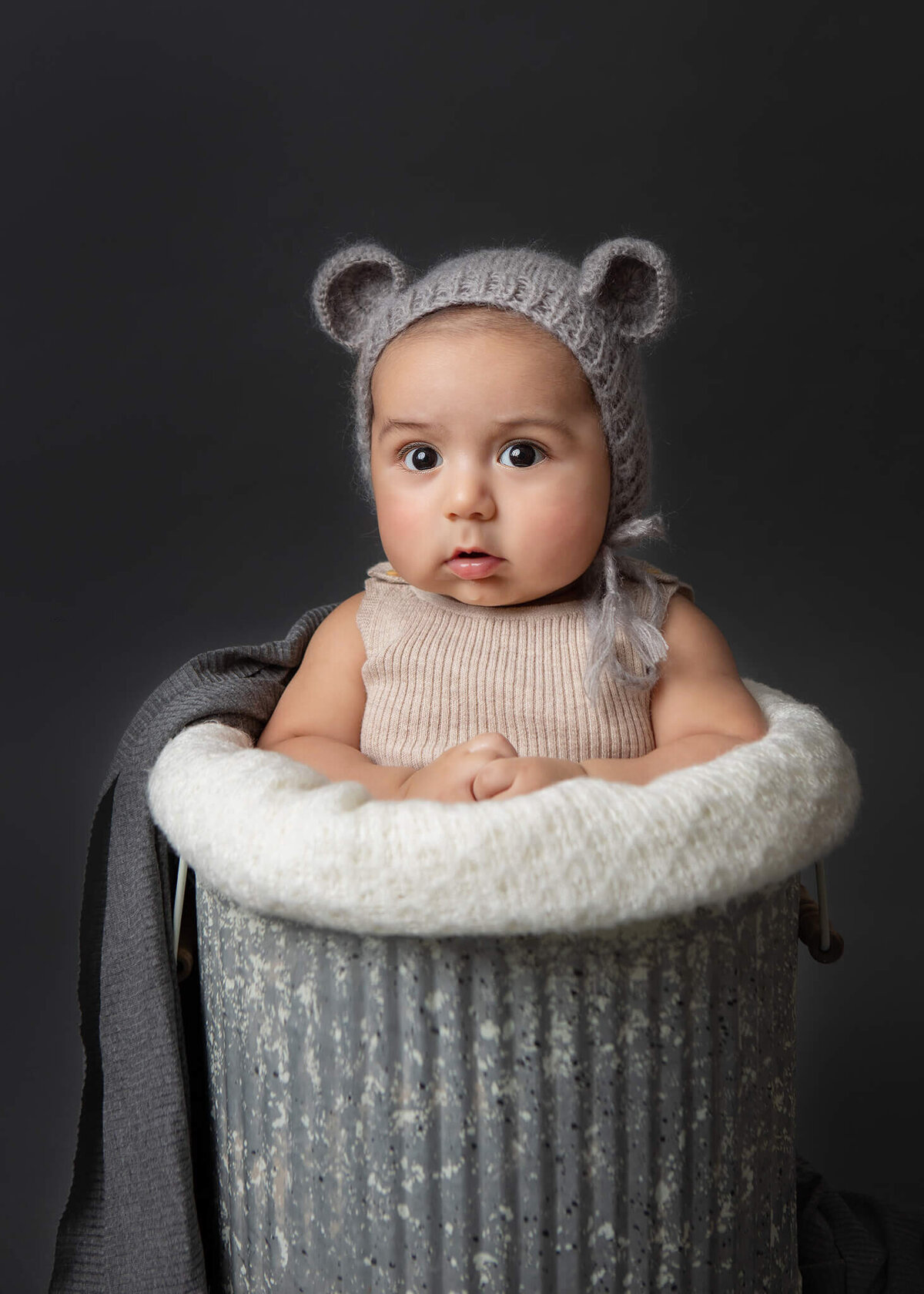 Baby in a little mouse bonnet sitting in a bucket photographed in Woodland Hills, CA