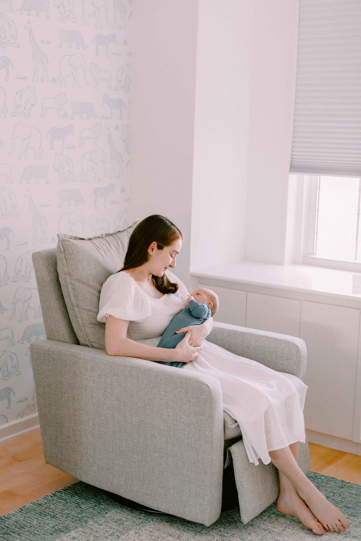 mom rocking newborn baby