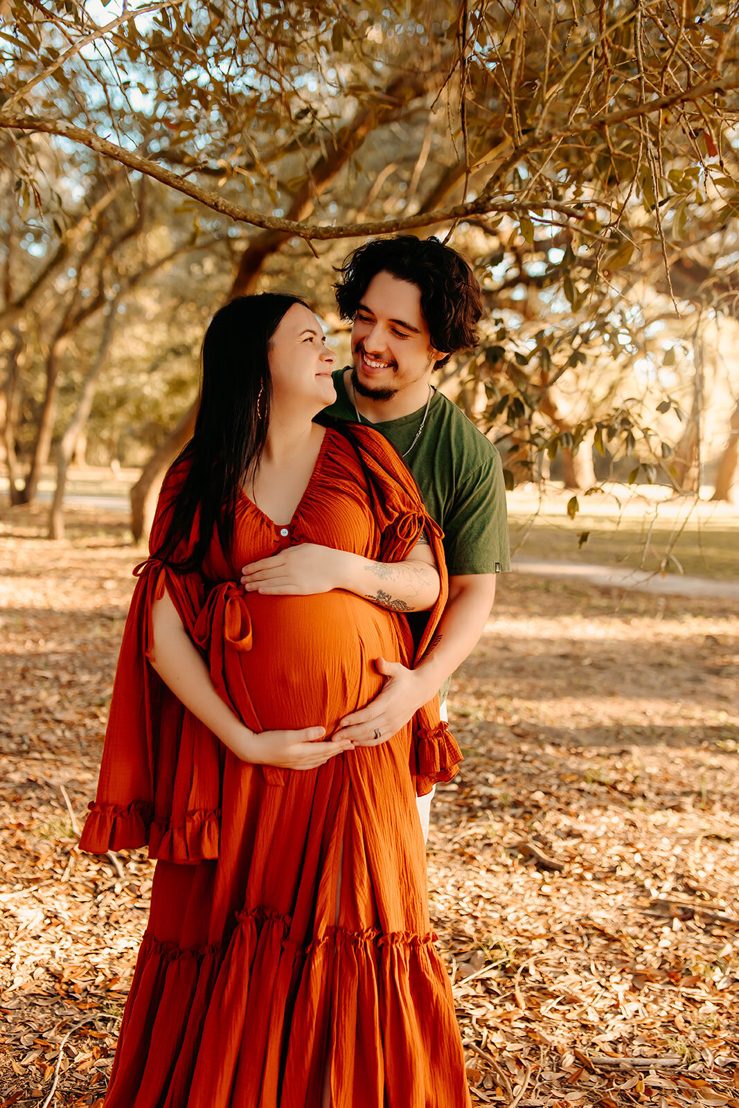 Houston TX maternity session—expecting couple under oak tree, dad holding baby bump