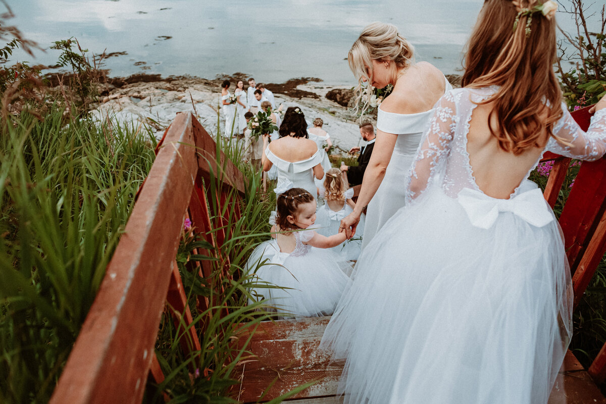 bridal-party-going-by-the-water-at-le-manoir-de-baie-comeau-1