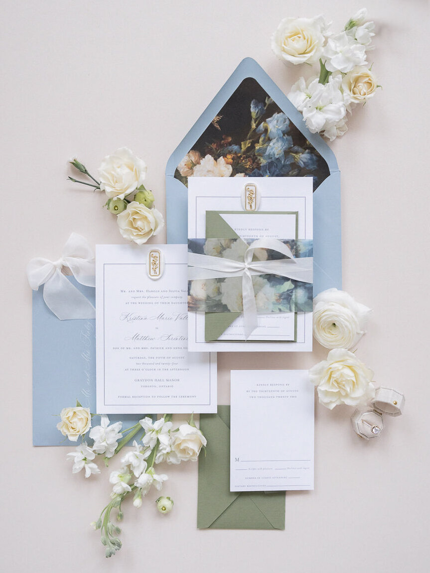 Vellum wrap with silk ribbon tied around invitation suite