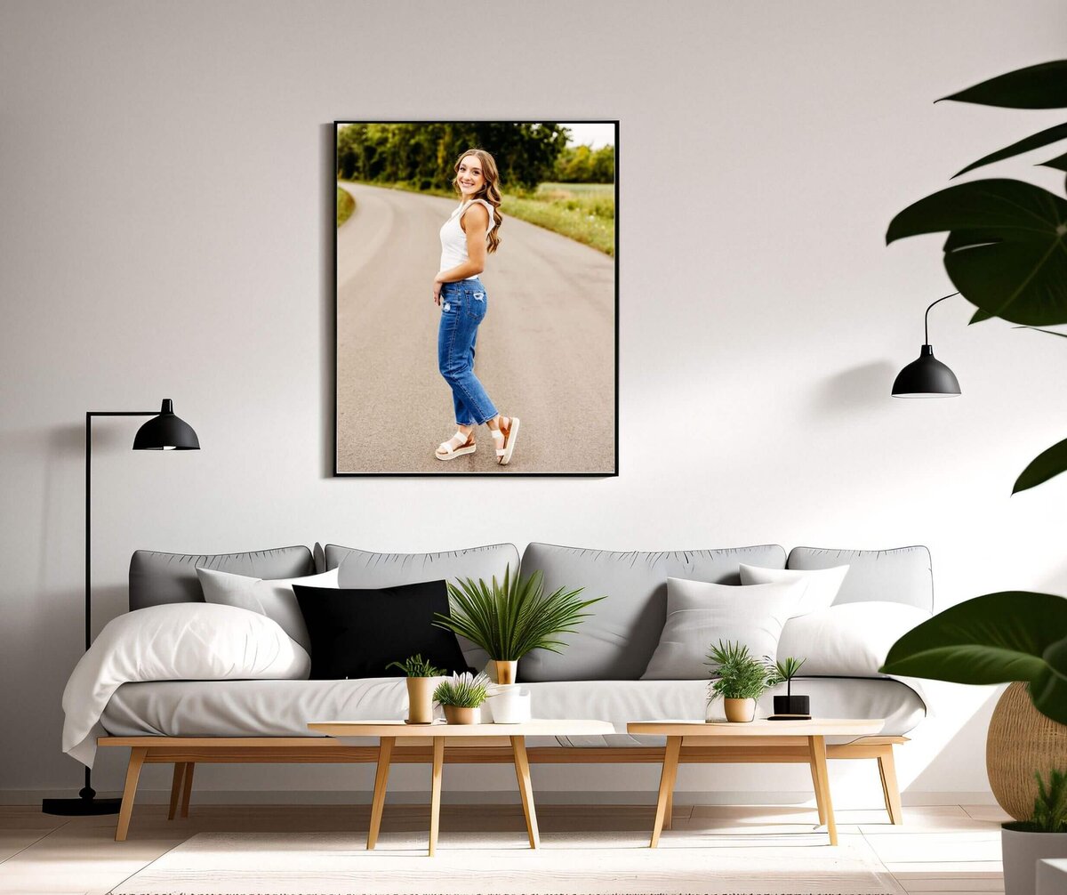 image of a gorgeous high school portrait in a black frame being displayed on a living room wall