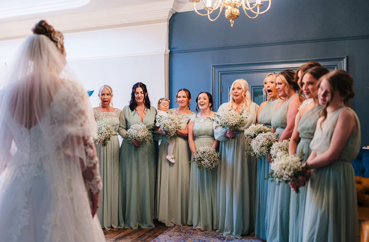 Bride revealing her wedding dress to her bridesmaids at Ashfield House picture taken by Anthony Horseman Photography and Film