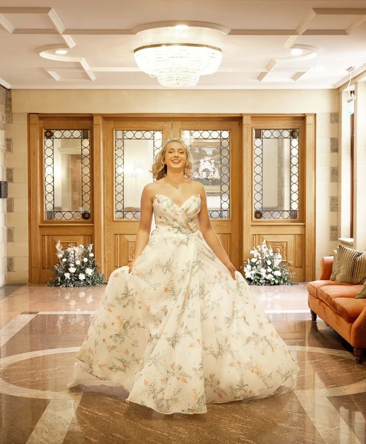 Bride running in a corridor holding her dress and laughing
