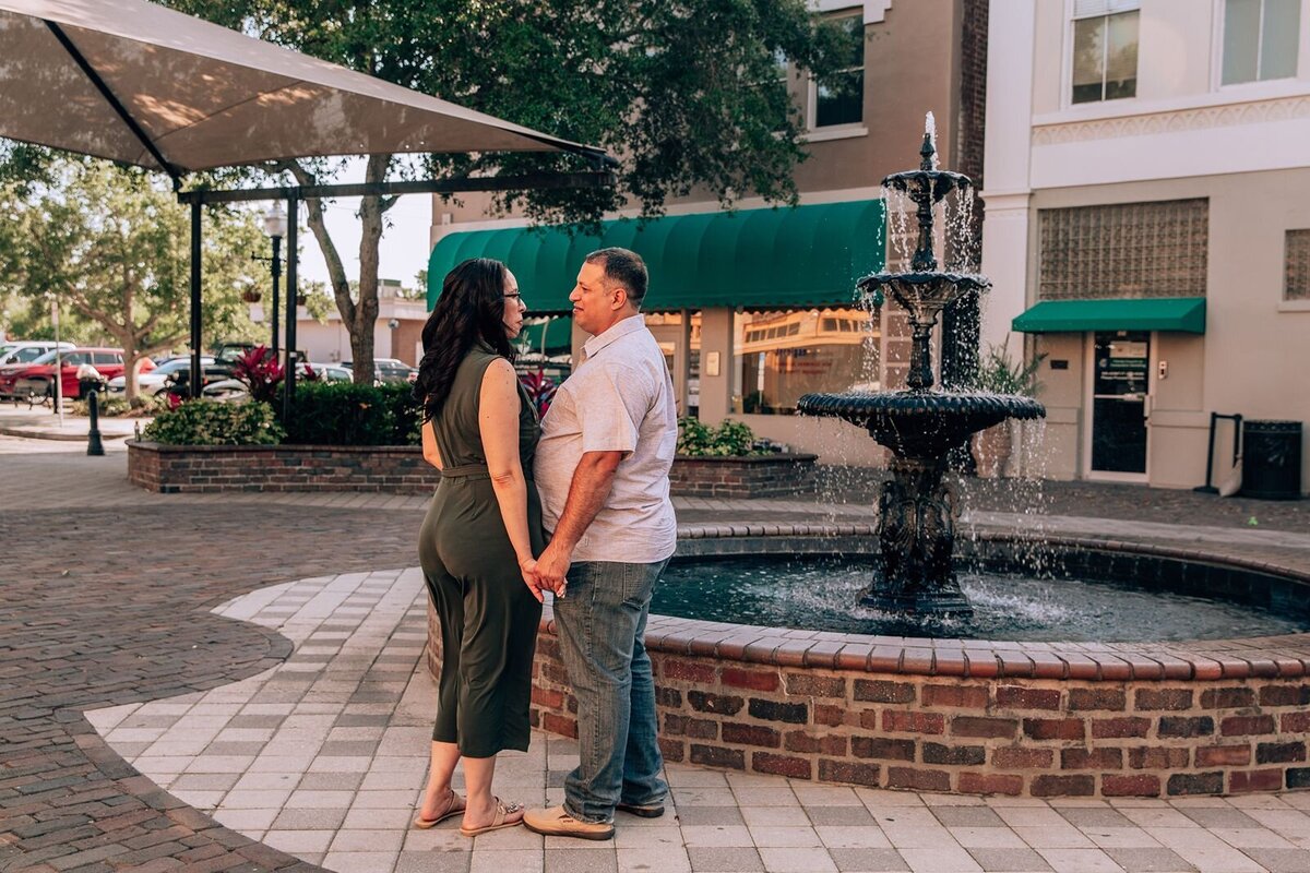 couple standing in front of a fountain in sanford florida