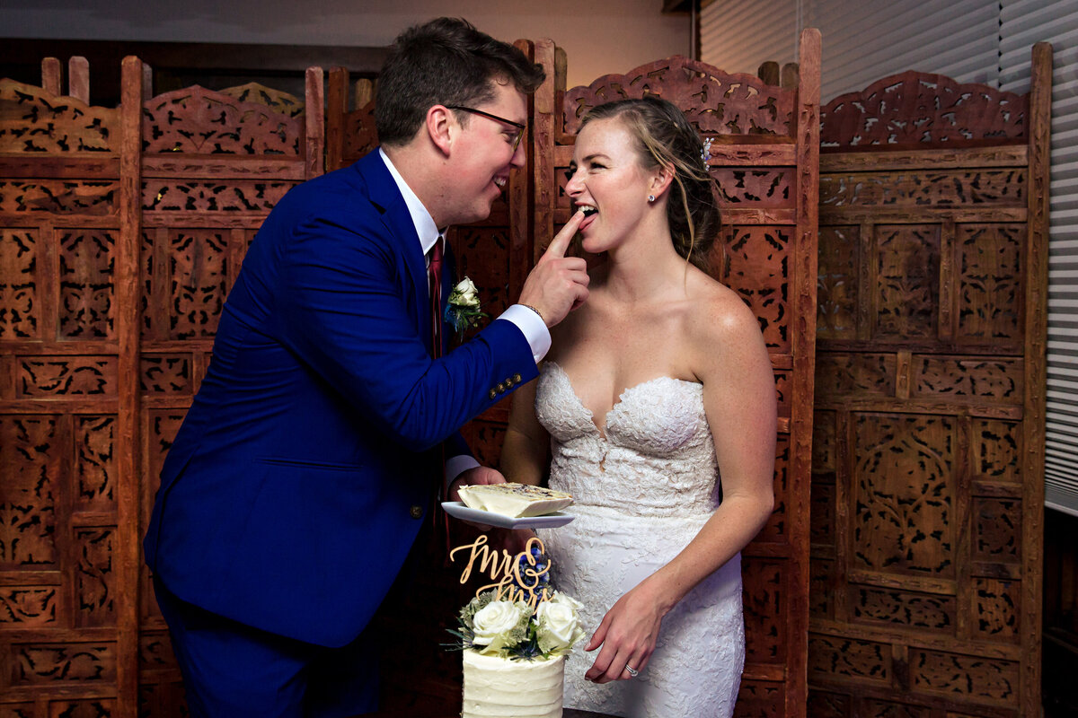 The couple get wild with the cake at their Bar Harbor Maine wedding reception