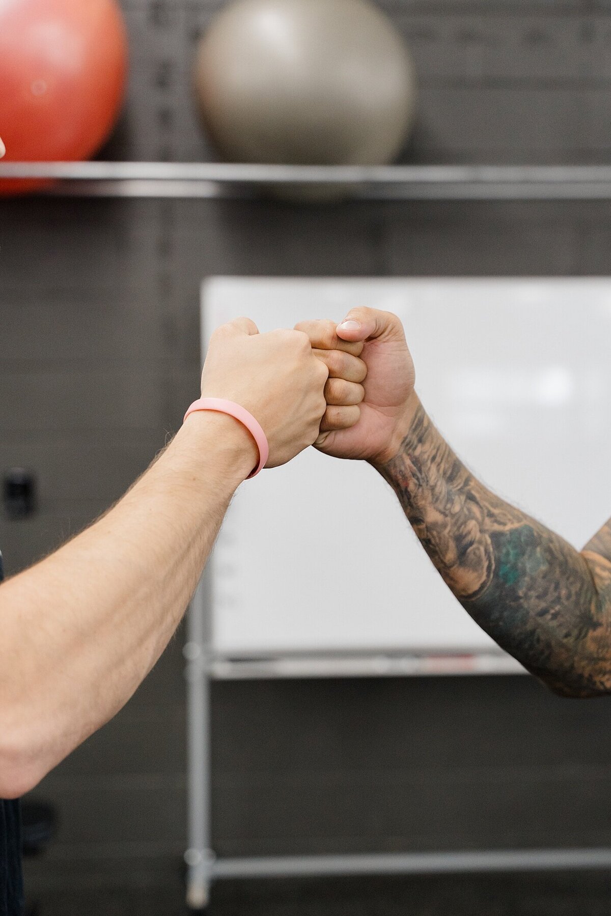 man and woman fist bump in the gym after a training session captured by Columbus photographer for personal branding photography