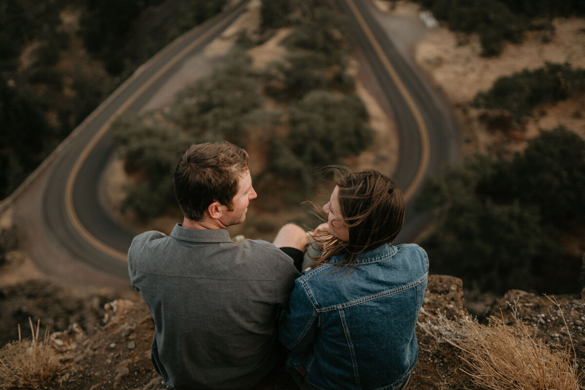 Couple sitting with views of u-shaped road