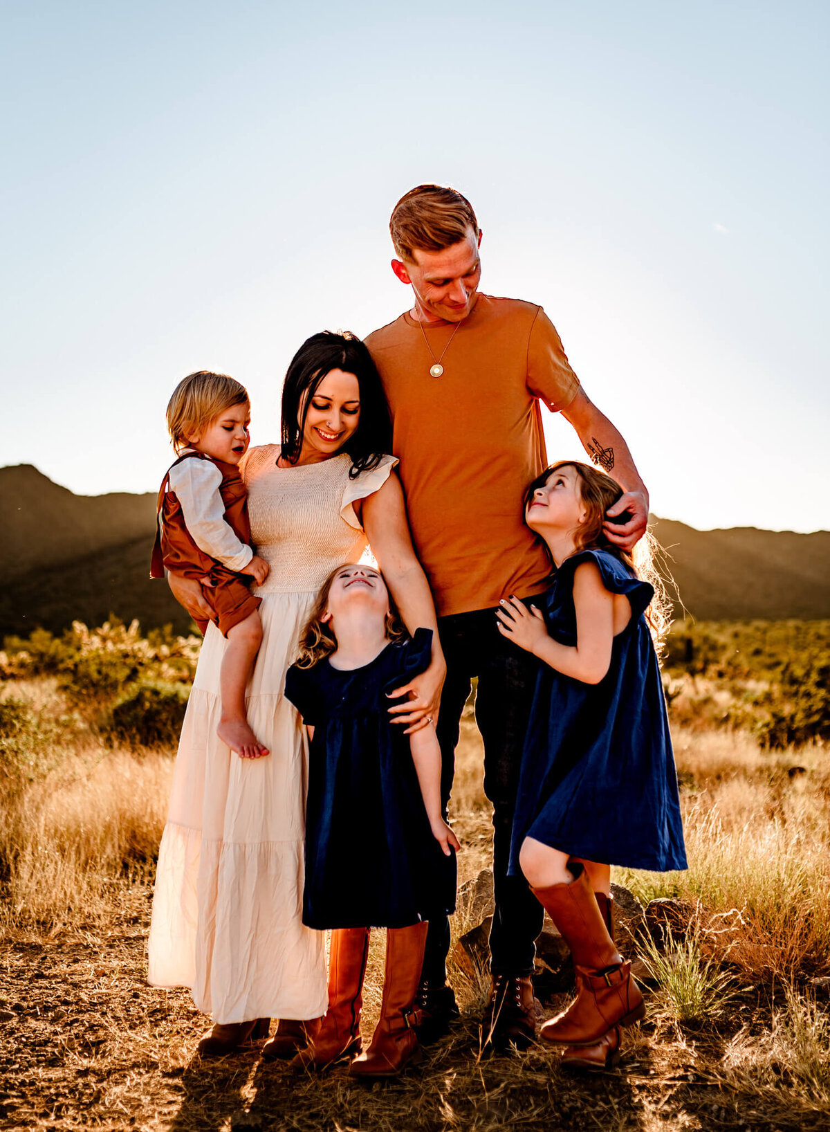 family cuddling in the Arizona desert during family photograph