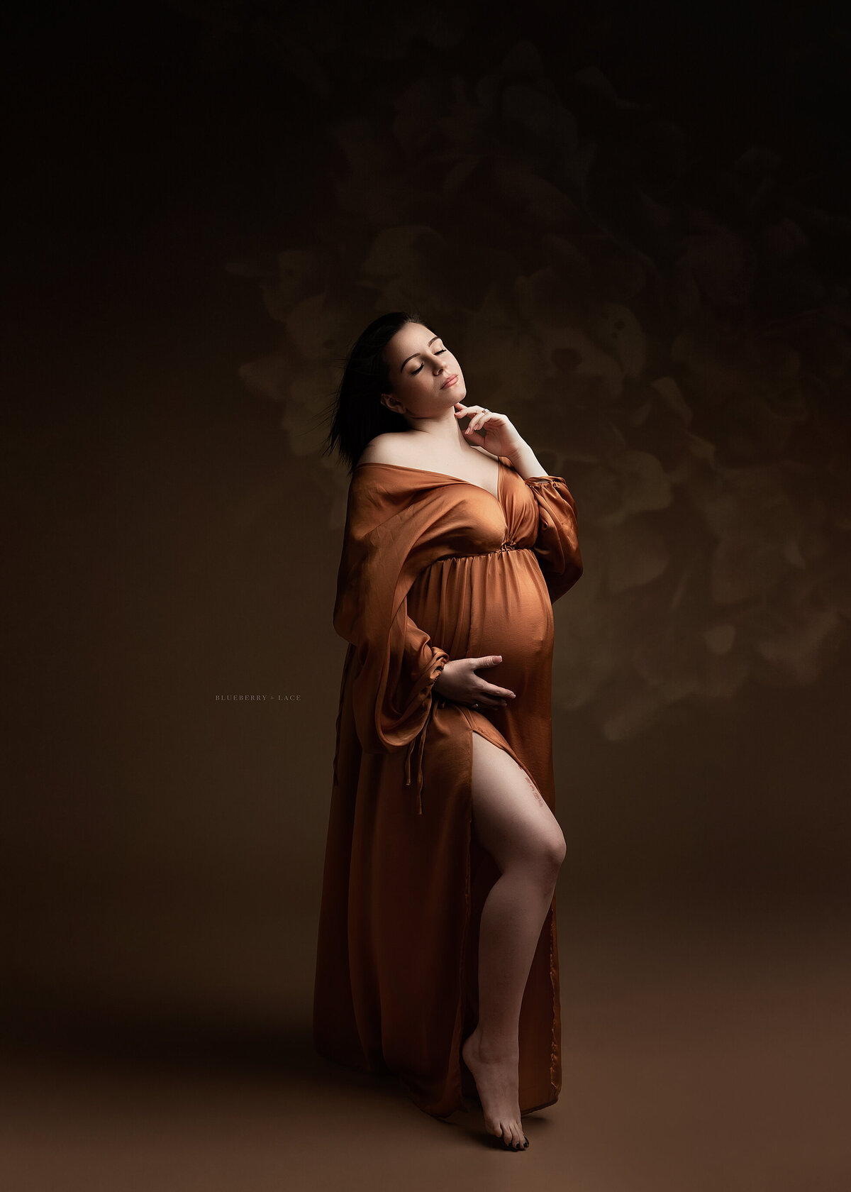 maternity mama wearing brown in studio setting florals and tasteful posing
