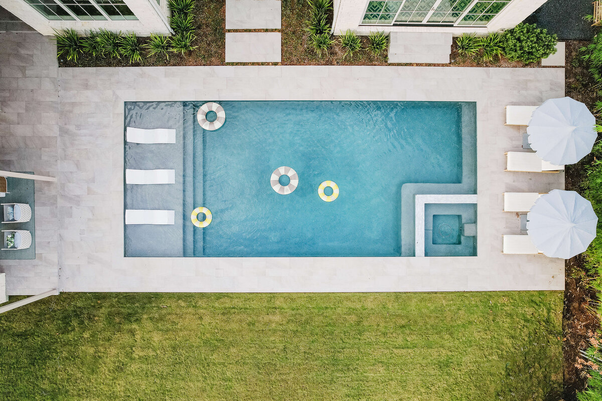 oyster creek studios memorial new build pool birds eye view with floats and seating