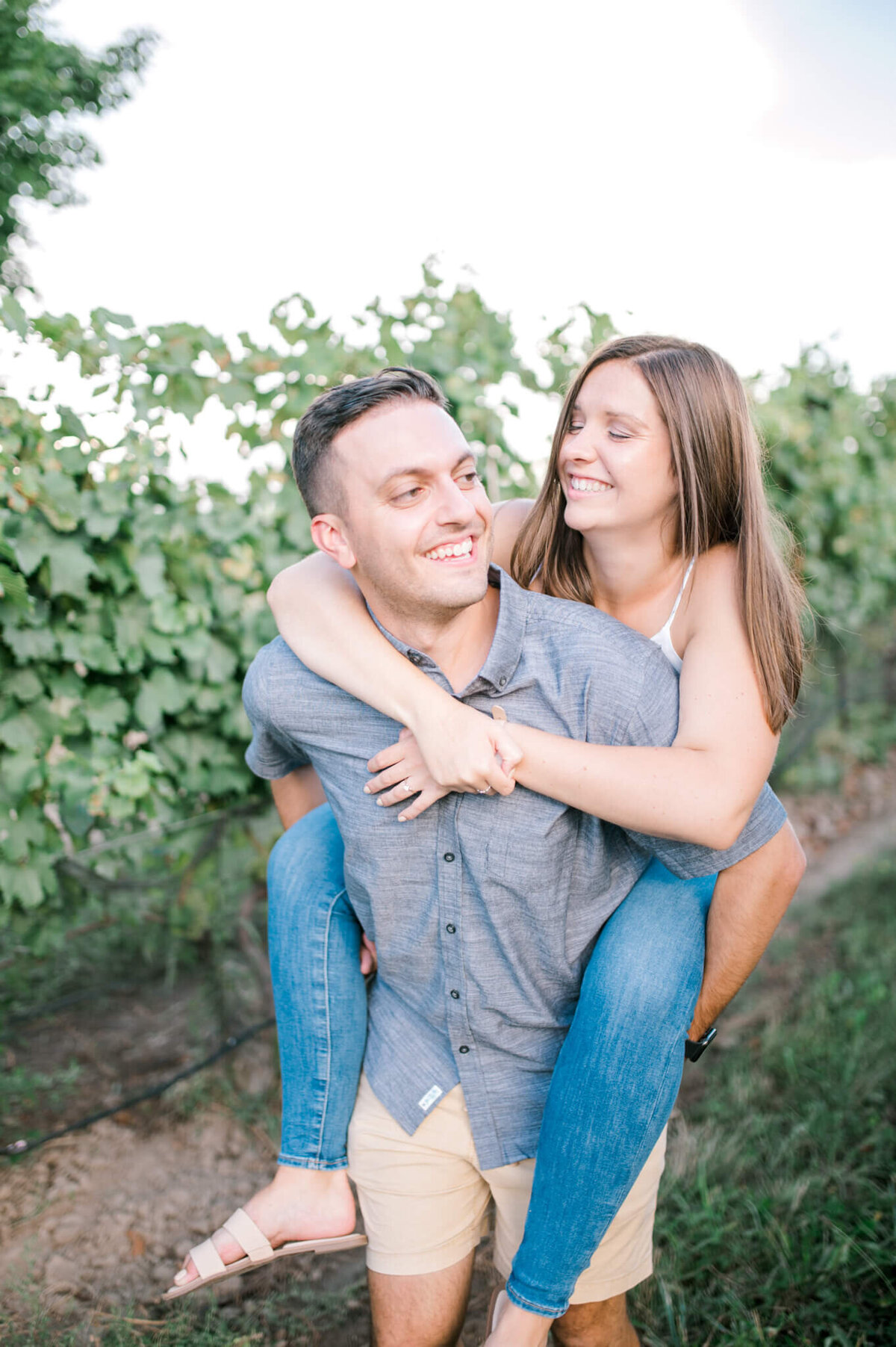 Man giving Woman a piggy back at a winery