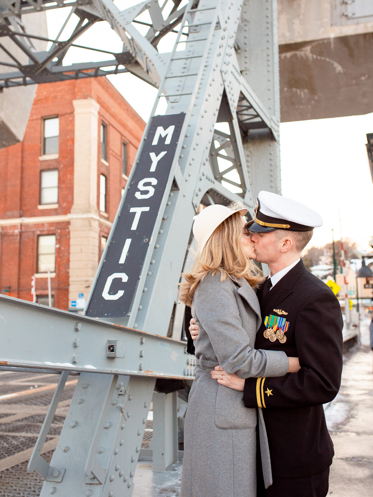 Navy couple kiss on the Mystic Bridge in Mystic, CT.