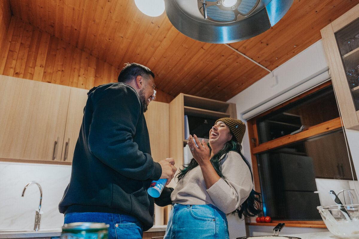 Husband and wife enjoy dessert in their Iceland cottage 