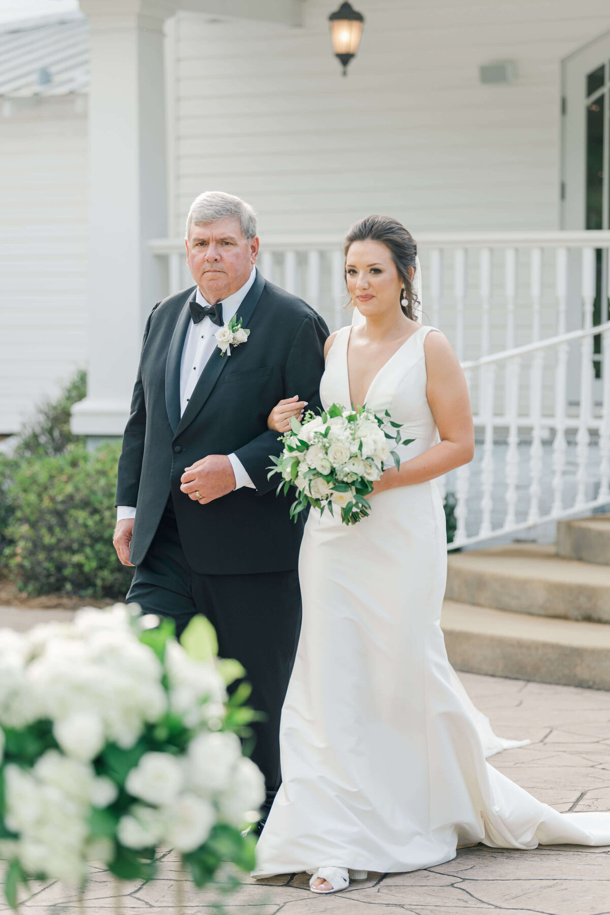 Bride and father of bride walking downt he aisle during wedding ceremony