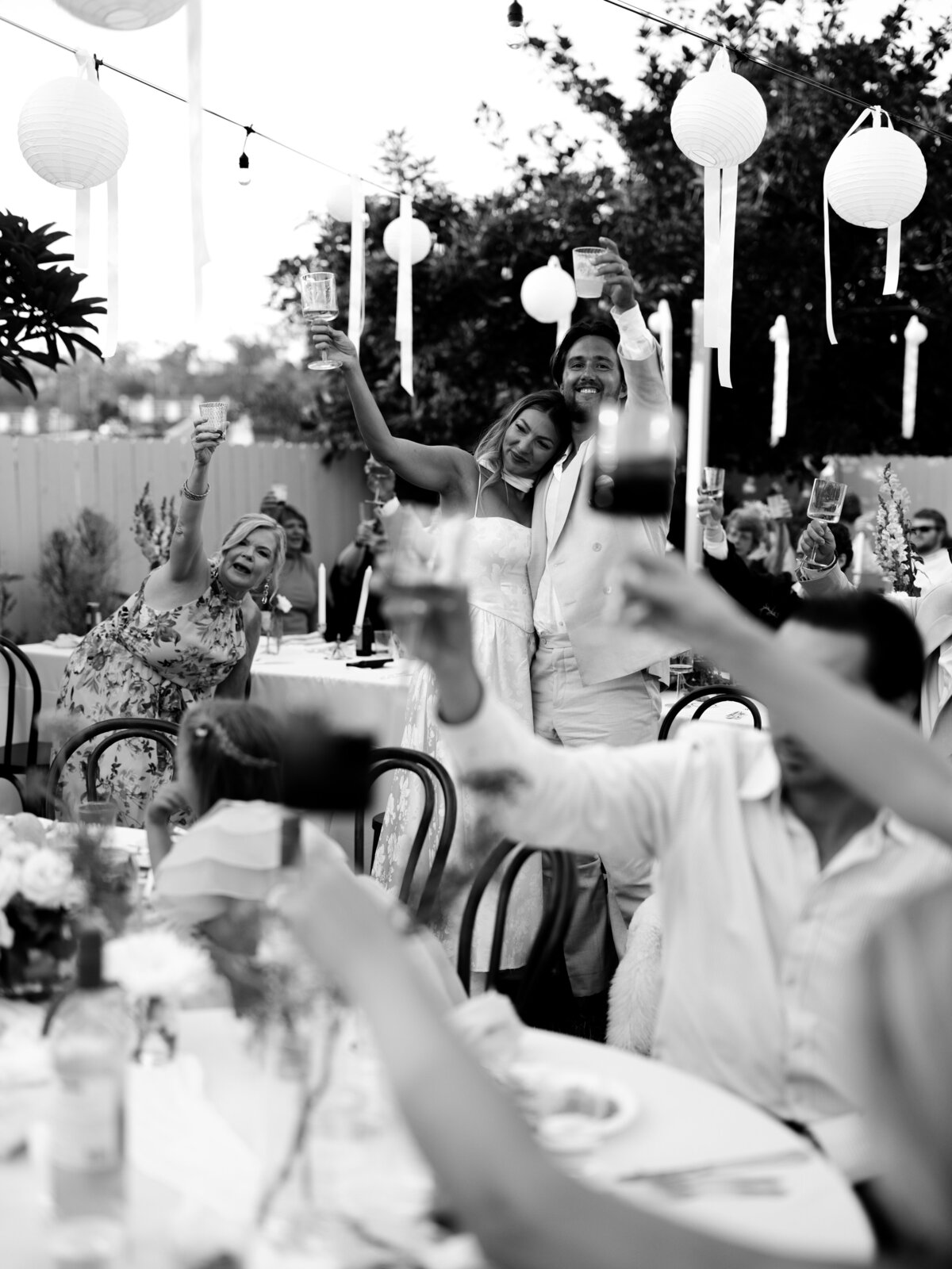 Guests raising glasses at backyard San Diego wedding