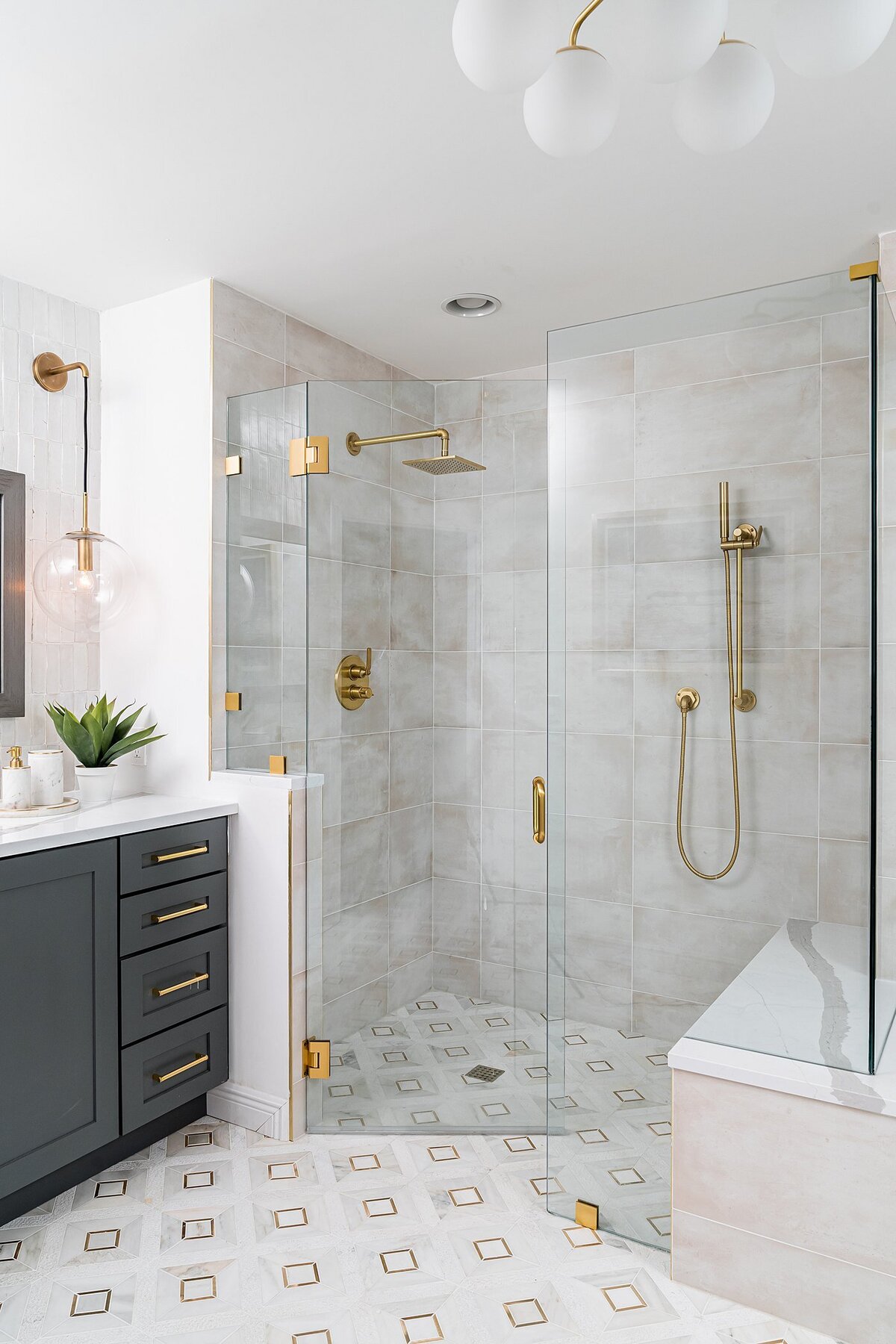 coastal luxury home Master Bathroom  modern glass enclosure shower with brass accents full service interior design by Island Home Interiors Lake Nona