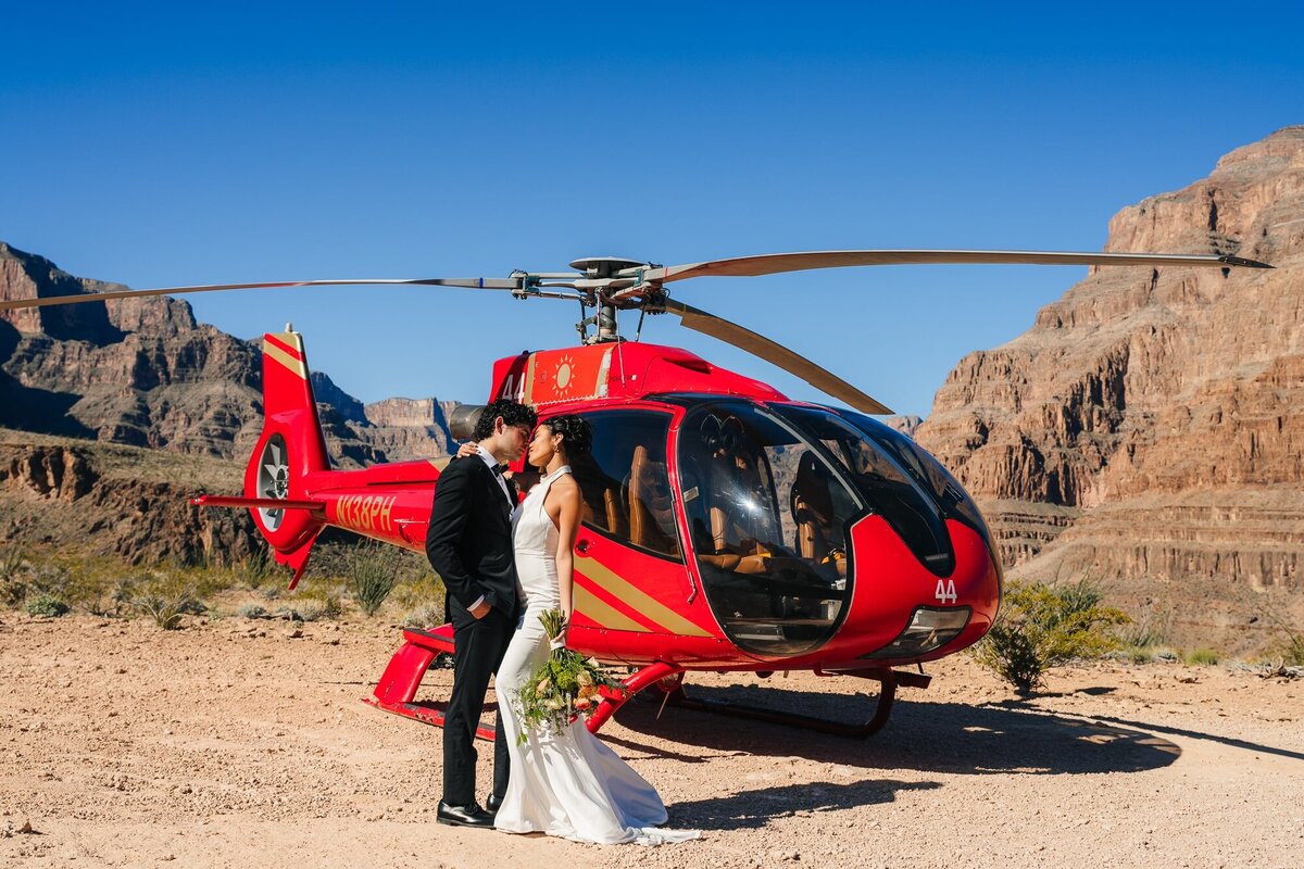 A couple in front of a helicopter during their elopement in Las Vegas.