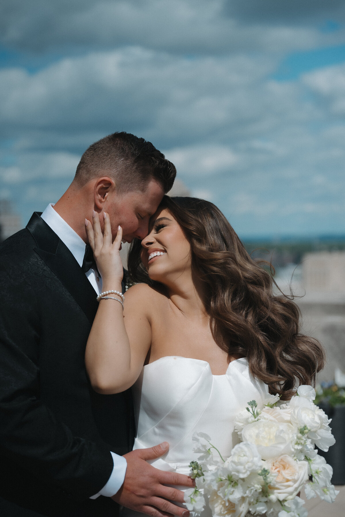 Luxury wedding photography by Kansas photographer Staci Brucks featuring bride and groom walking hand in hand through scenic landscape
