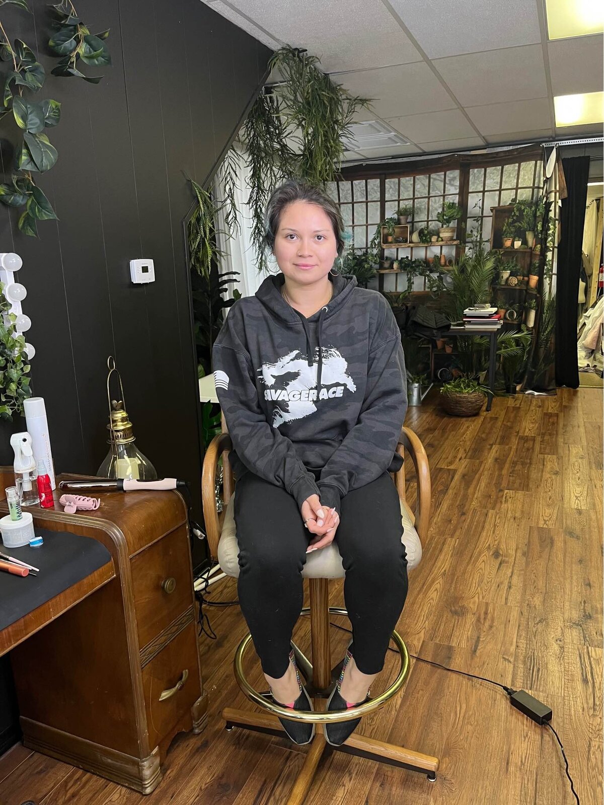 a woman poses in the hair and makeup chair