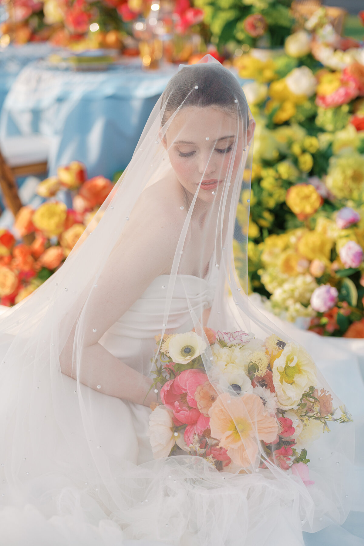 bridal portrait with colorful bouquet, Mimi's Couture gown, and large veil at Lone Summit Ranch