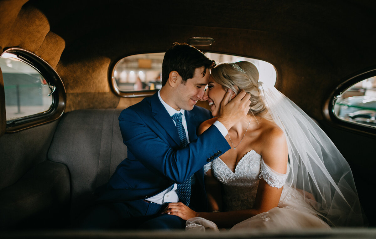 Bride and groom portraits in a vintage car at the Packard Proving Grounds