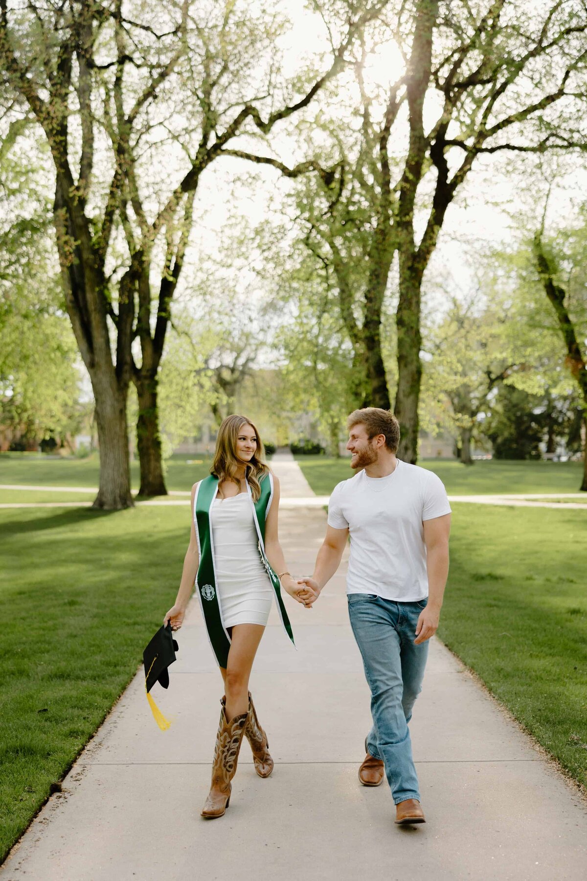 A couple holds hands during their CSU Grad Shoot in Fort Collins, Colorado.