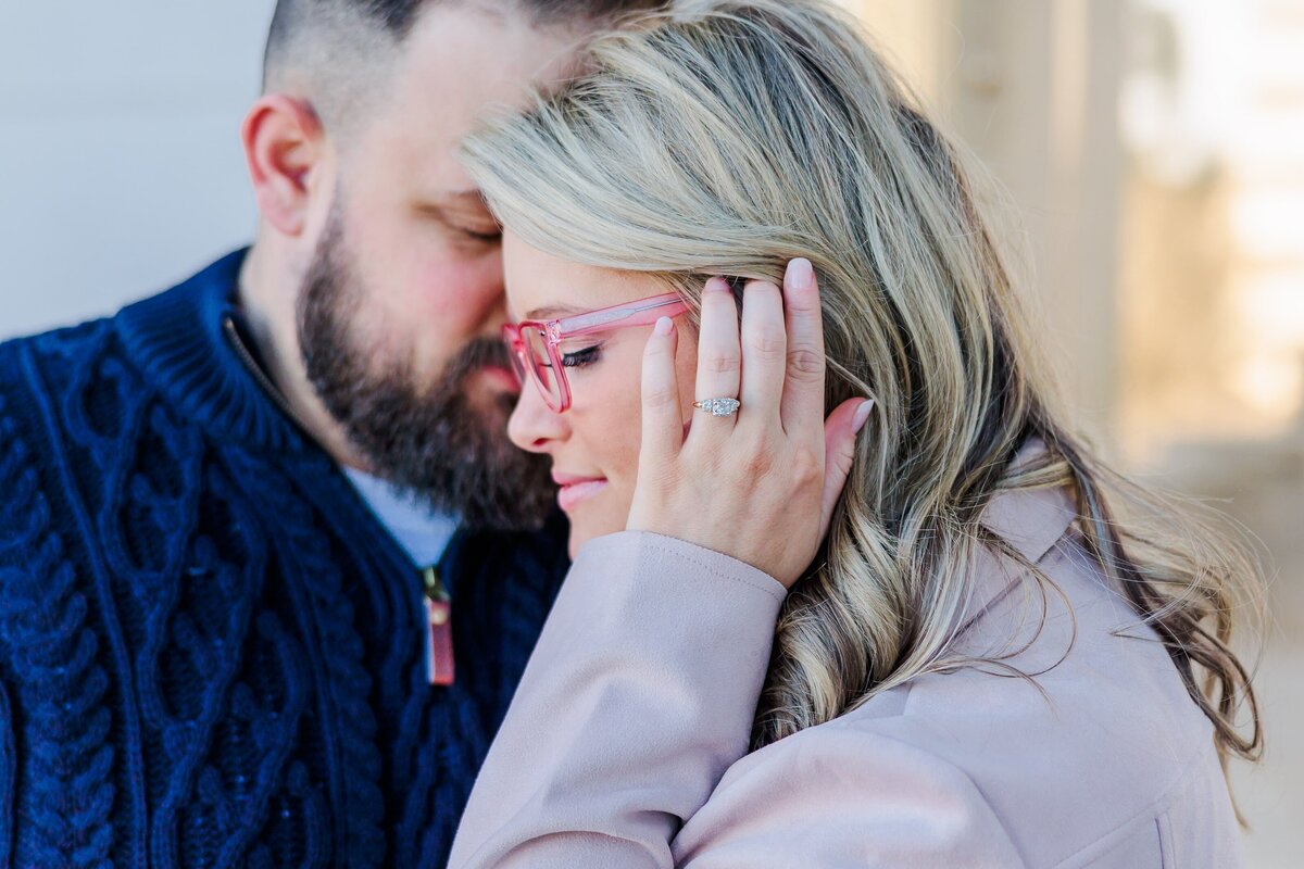 A close up of a couple with engagement ring outside the Arkansas state capitol.
