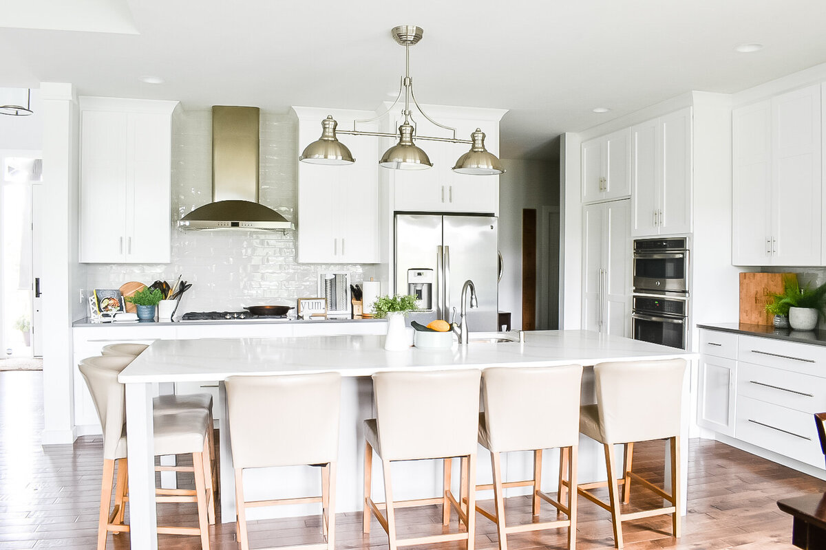 A bright kitchen with white cabinets and a large kitchen island