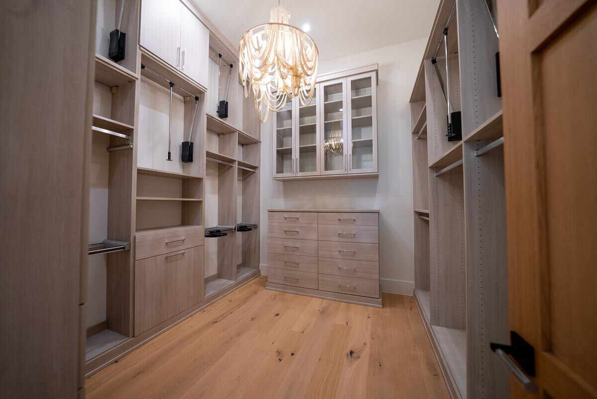 Large and luxurious primary closet inside custom home