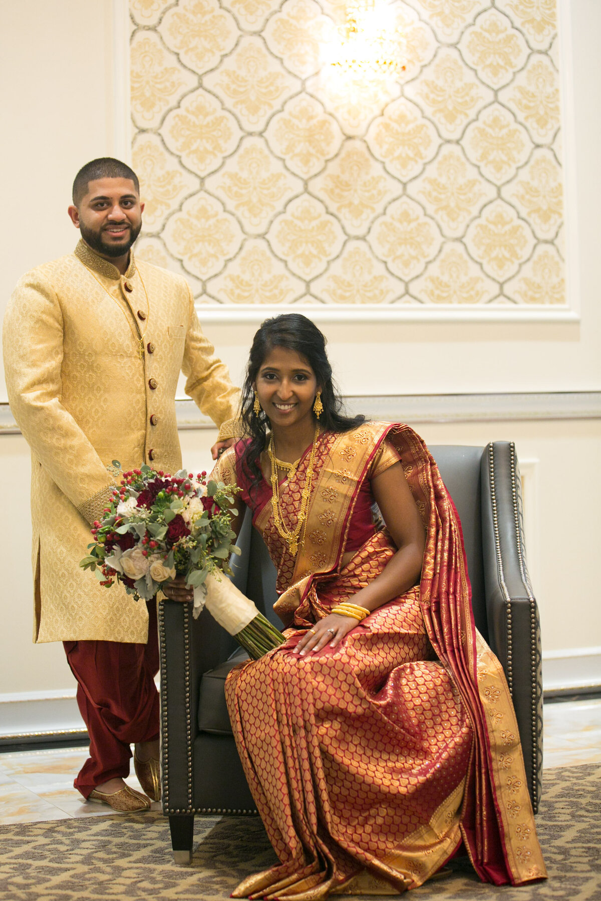 njeri-bishota-lauren-ashley-traditional-indian-wedding-bride-sitting-groom-standing-floral-bouquet