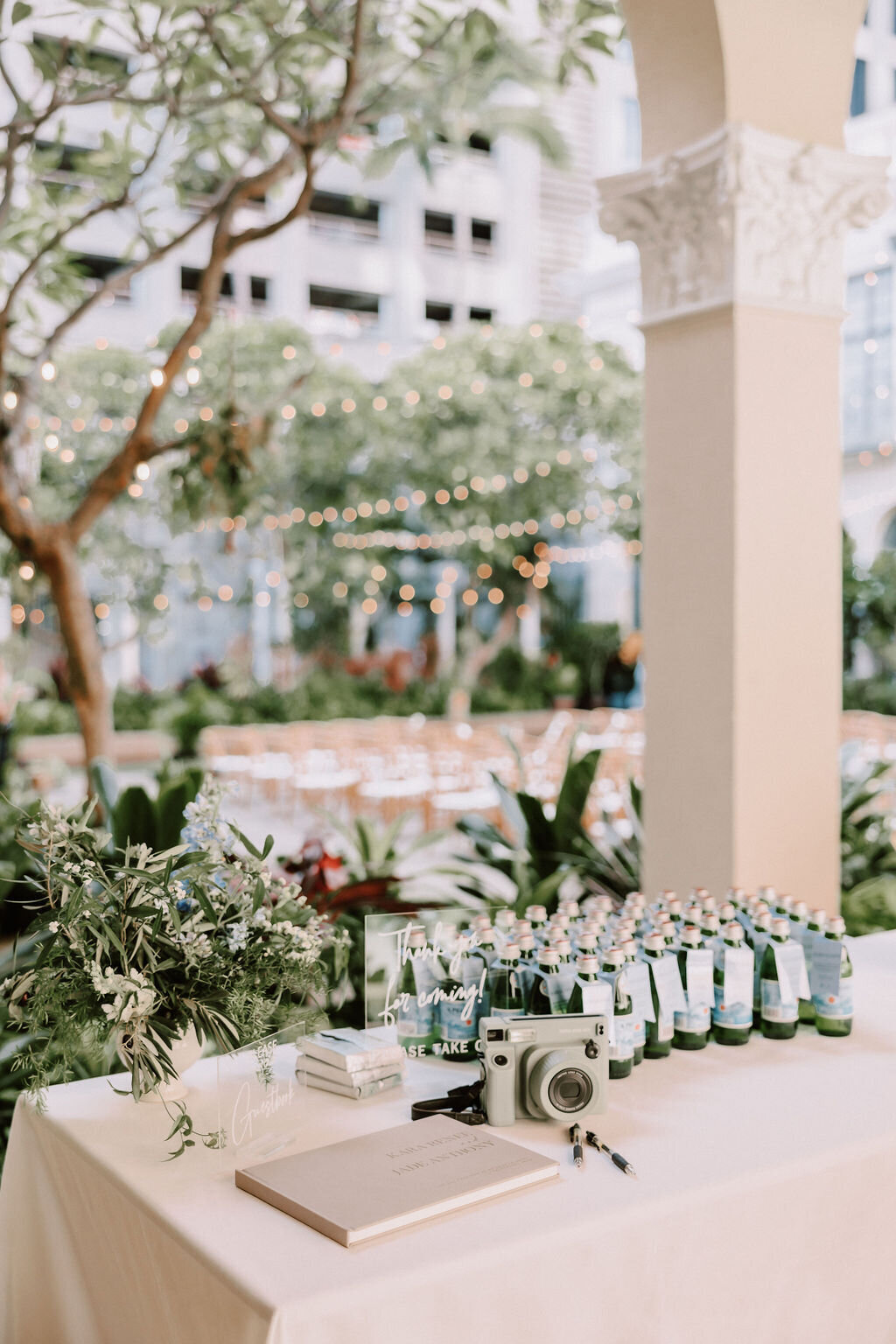 table camera, film and with various signs on it and ceremony chairs in the background with european architecture