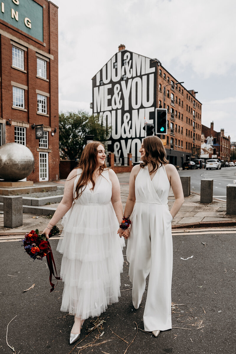 Same sex wedding couple Leeds city, by the Me and You wall