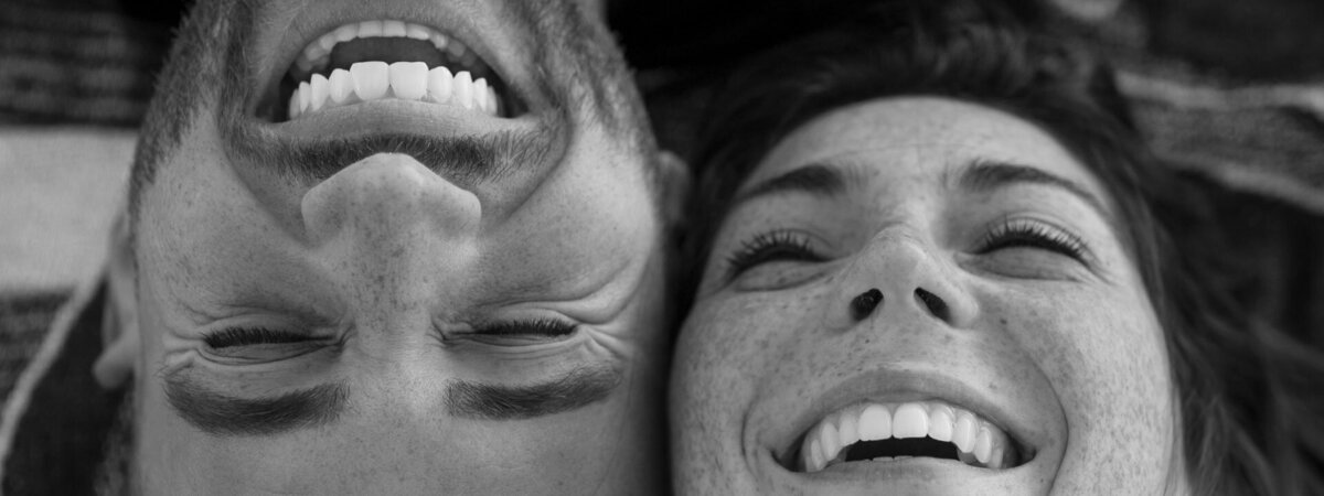 close up of couple laughing showing teeth