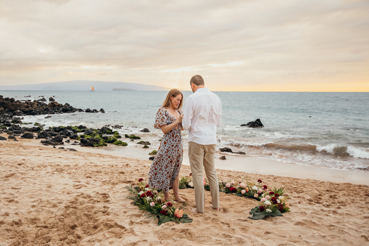 Hawaii Engagement Photographer captures man putting ring on woman's finger