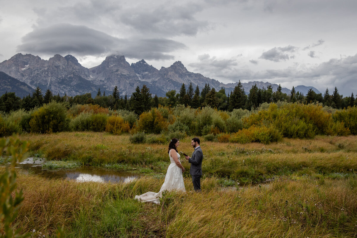 A groom reads his vows to his bride in private on their Wyoming elopement day.