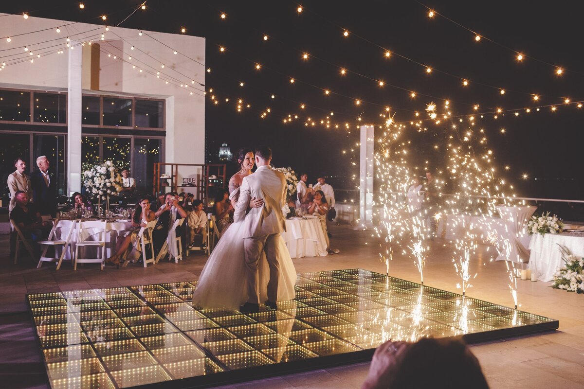 Bride and grooms first dance with fireworks at Hyatt Ziva wedding in Cancun