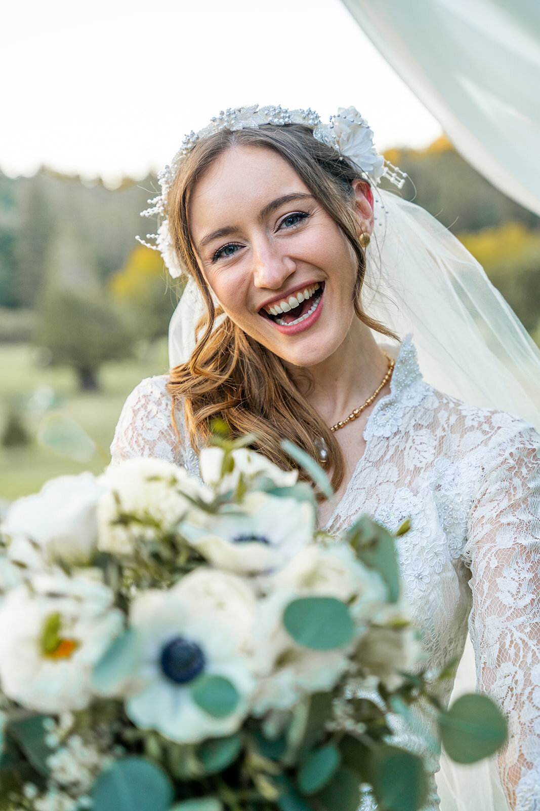 kona wedding photography with bride smiling and holding floral bouquet