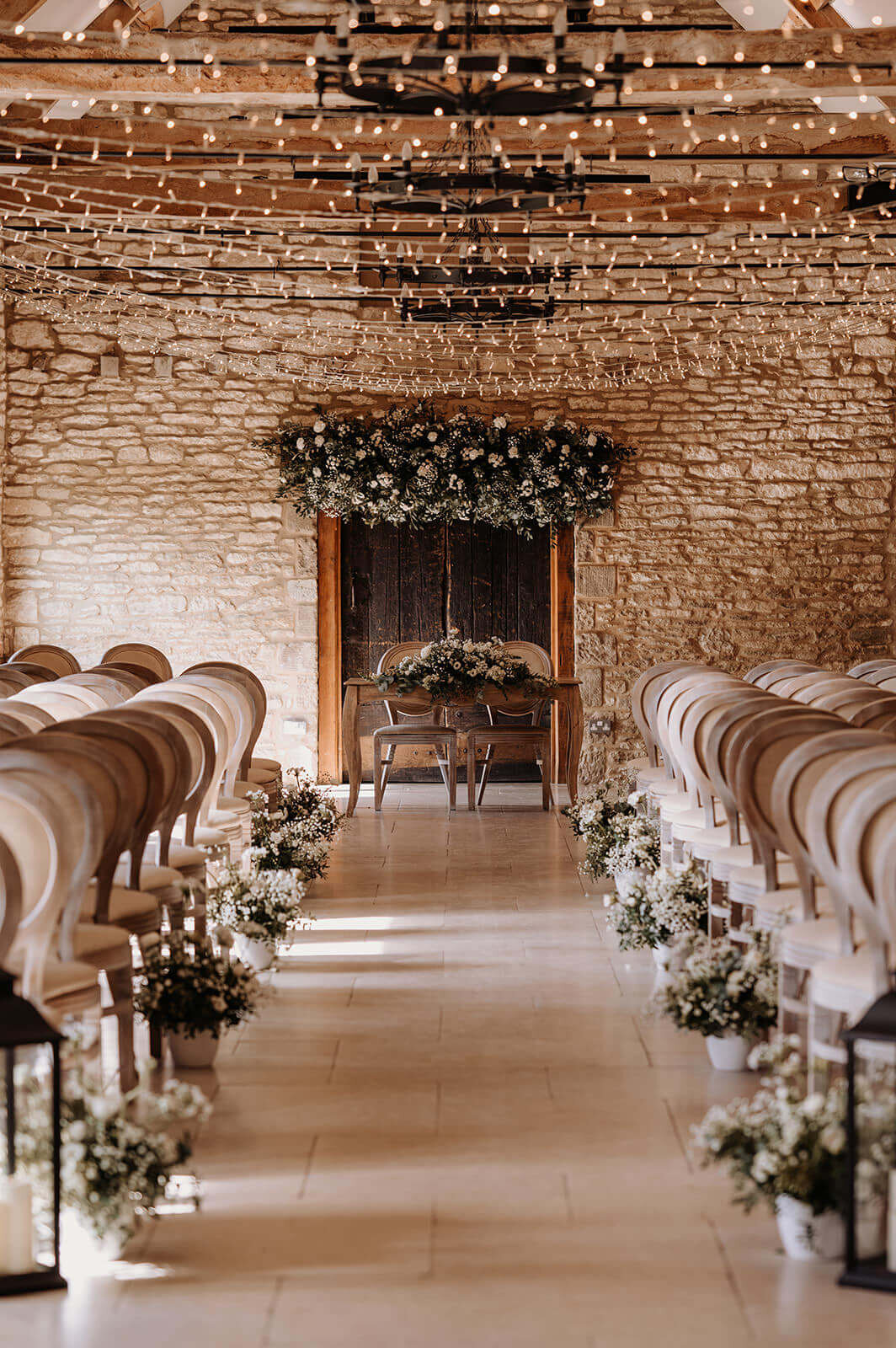Winter wedding ceremony at Caswell House with magical fairy lights creating a romantic glow