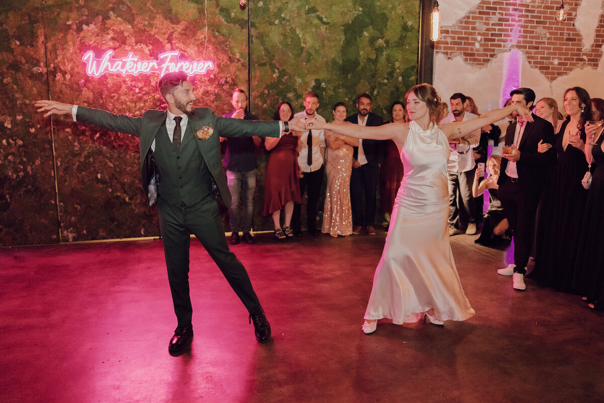 denver-wedding-venue-the-moss-couple-first-dance-floor-custom-neon-sign