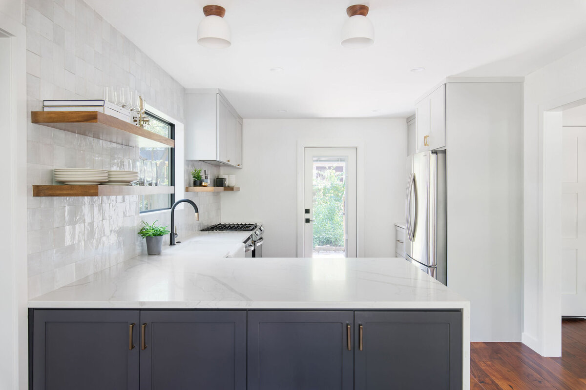 hello-home-two-tone-cabinets-kitchen-remodel-hardwood-flooring-waterfall-peninsula-zellige-backsplash-austin-5
