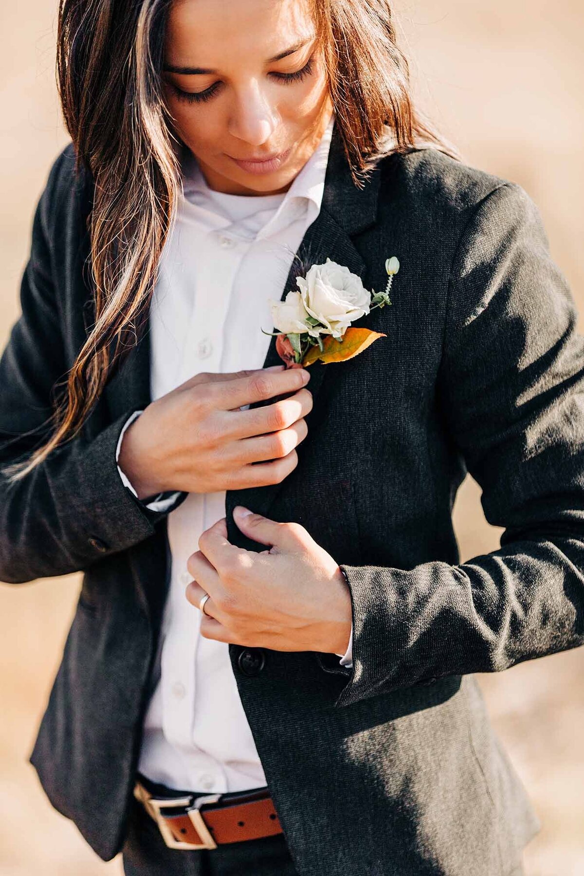 Missoula same sex bride putting on boutonniere